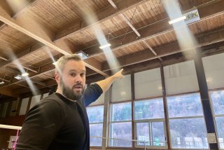 Christian Champagne montre la structure du toit qui menace de s'effondrer, juste au-dessus des terrains de badminton