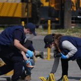 Des enquêteurs médico-légaux placent des marqueurs de preuves sur les lieux où les deux policiers ont été tués lors d’attaques survenues dans une prison abritant des chefs de gangs, à Villanueva, en périphérie de Guatemala City. KEYSTONE/AP/Moises Castillo