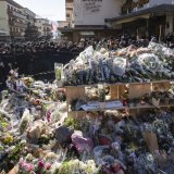 KEYPIX - The firefighters, sapeurs-pompiers de Crans-Montana, first responders in the fire at the 'Le Constellation' bar and lounge, show emotions as they gather around flowers and candles to commemorate the victims, in Crans-Montana, Switzerland, on Sunday, January 4, 2026. 40 persons lost their lives and over 100 were severely injured in the fire at the bar 'Le Constellation' on New Year's Eve in the Swiss Alps resort of Crans-Montana. (KEYSTONE/Jean-Christophe Bott)