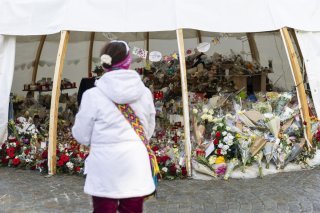 KEYPIX - Flowers and candles are pictured in tribute to the victims after the fire at the