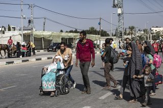 Jeudi, comme la veille, une foule d'hommes et de femmes à pied, portant leurs enfants dans les bras, les mains vides ou emportant de petits baluchons, ont envahi la route menant vers le sud de la bande de Gaza. KEYSTONE/EPA/HAITHAM IMAD